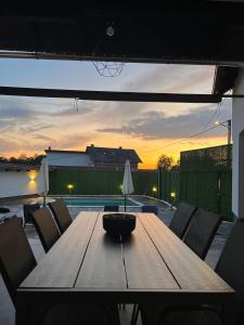 a wooden table with chairs and a bowl on a patio at House Karla in Cerovac Barilovički