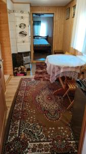 a living room with a table and a rug at Садиба Трембіта in Pilipets