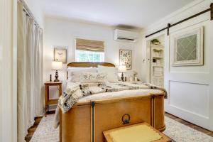 a bedroom with a large bed and a window at Shepard Cottage Near Wilmington and Wedding Venue in Burgaw