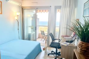 a bedroom with a bed and a desk and chairs at Appartement spacieux, vue imprenable in Roquebrune-Cap-Martin +25 photos