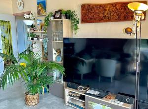 a living room with a large flat screen tv at Appartement spacieux, vue imprenable in Roquebrune-Cap-Martin