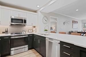 a kitchen with black cabinets and a white counter top at St James Place 216 in Beaver Creek