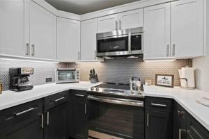 a kitchen with white cabinets and a stove top oven at St James Place 216 in Beaver Creek