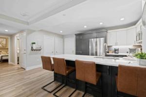 a kitchen with a large kitchen island with chairs at St James Place 216 in Beaver Creek