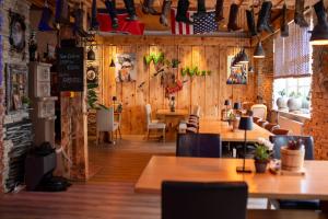 a restaurant with wooden walls and tables and chairs at Das kleine Landhotel im Fichtelgebirge in Fichtelberg