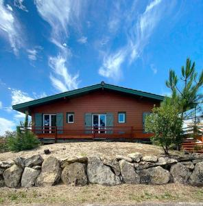 a house on a hill with a stone wall at Résidence 03134-lacanau Ocean - Chalet bois indépendant, 3 chambres, 6 personnes proche plage Lacanau océan MAE-0531 in Lacanau