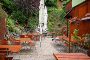 a patio with tables and chairs with an umbrella at Das kleine Landhotel im Fichtelgebirge in Fichtelberg