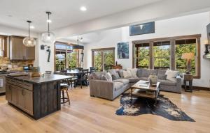 a living room with a couch and a table at Prospector Pines Treetop Escape in Suncadia- Fairway View, BBQ, Outdoor Fireplace, Smart TVs, Hi-speed Wi-Fi in Cle Elum