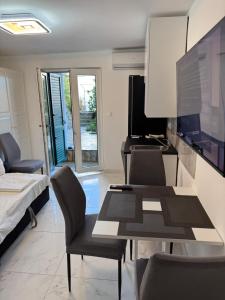 a living room with a table and a tv at Villa Lopar in Lopar