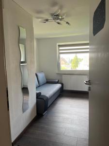 a living room with a couch and a window at Auszeit in Lügde