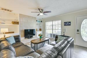 a living room with a leather couch and a flat screen tv at Pet-Friendly Home with Lanais, Near Dtwn Tampa! in Seffner