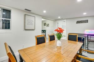 a dining room table with chairs and a vase of flowers at Pet-Friendly Home with Lanais, Near Dtwn Tampa! in Seffner