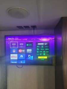 a television in a room with purple lights on it at Cozy Camping in Hot Springs