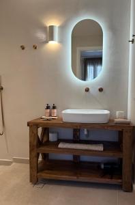 a bathroom with a sink and a mirror at Aside Lefkes in Dhriopís +39 photos