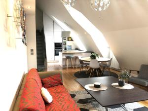 a living room with a couch and a table at Duplex moderne vue MontBlanc, Cœur de Chamonix in Chamonix-Mont-Blanc