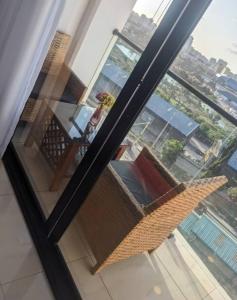 a glass window with a view of a balcony at Dar es Salaam Marina Apartments in Dar es Salaam