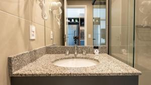 a bathroom with a sink and a shower at Studios modernos e completos ao lado da estação Vila Mariana in Sao Paulo +126 photos