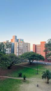 a park with trees and buildings in a city at Liza Luxury Holiday Apartment Oceanic 44 in Durban +57 photos