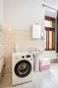 a washing machine in a bathroom with a sink at Royal Charlie Suite in Prague +37 photos