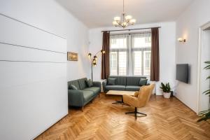 a living room with a couch and a chair at Royal Charlie Suite in Prague