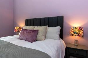 ein Schlafzimmer mit einem großen Bett mit zwei Lampen in der Unterkunft Central Saltburn 2 bed family apartment in Saltburn-by-the-Sea