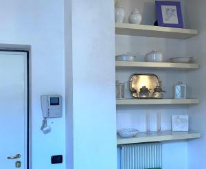 a room with shelves with vases and dishes on them at Bilocale atelier in centro storico in Parma