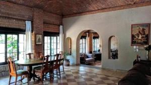 a living room with a table and chairs at Casona María Esther in San Miguel de Allende