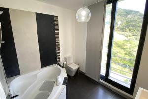 a white bathroom with a tub and a toilet at Sal e Pimenta House - A Wellbeing Retreat in Machico