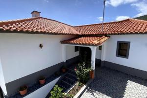 a white house with a red tile roof at Viva Village in Gaula