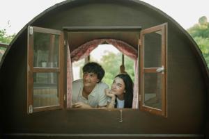 a man and a woman looking out of a window at Glamping Il Rifugio dei Marsi in Ascoli Piceno