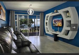 a living room with a couch and a flat screen tv at 7 Shelly Palms in Margate