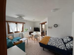 a bedroom with a bed and a living room at Sun Studio Tenerife in Arona