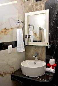 a bathroom with a sink and a mirror at Casa Angel in Morelia