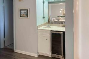 a bathroom with a sink and a mirror at Dunescape Villas 252 in Atlantic Beach
