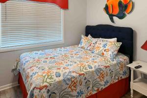 a bedroom with a bed with a blue headboard at Dunescape Villas 252 in Atlantic Beach