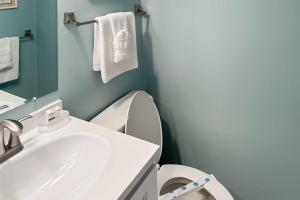 a bathroom with a sink and a toilet and towels at Dunescape Villas 252 in Atlantic Beach +15 photos