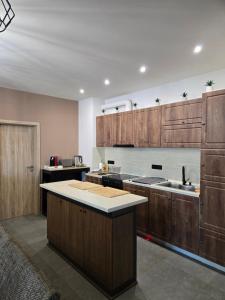 a kitchen with wooden cabinets and a counter top at Къща за гости Вила Буч in Kvartal Mala Kutlovitsa