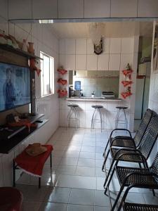 a kitchen with chairs and a table and a counter at Residencial in Belém