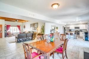 a dining room and living room with a table and chairs at Bear Canyon Casa - Tucson Home Base with Mtn Views in Tucson
