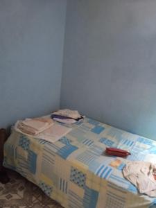 a bed with a quilt on it in a room at Residencial in Belém