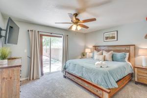 a bedroom with a bed and a ceiling fan at Bear Canyon Casa - Tucson Home Base with Mtn Views in Tucson +24 photos