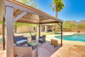 a pavilion with a table and chairs next to a pool at Bear Canyon Casa - Tucson Home Base with Mtn Views in Tucson