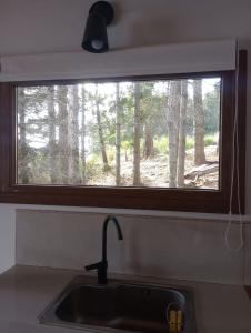 a kitchen sink with a window in a kitchen at Suite del muelle in San Carlos de Bariloche