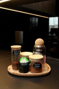 a tray with jars of condiments on a table at Urban Nest Nis in Niš