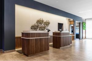a lobby with a reception desk in a building at Courtyard by Marriott Madison in Madison +27 photos