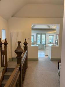 a living room with a staircase and a kitchen at Merchants House in Penryn