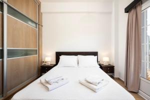 a bedroom with a bed with two towels on it at Anagenna in Kos Town