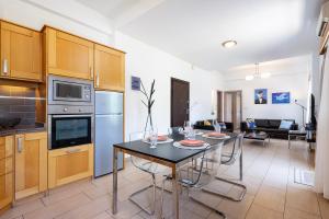 a kitchen and living room with a table and chairs at Anagenna in Kos Town