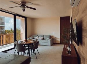 a living room with a table and a couch at Golden Hour 2BR Ocean View Apt in Holbox Island