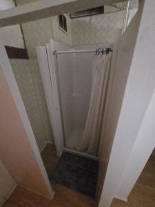 a bathroom with a shower with a shower curtain at Coal Branch Hotel & Restaurant in Coalspur